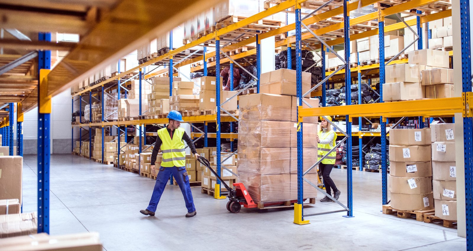 Warehouse,Workers,Pulling,A,Pallet,Truck.