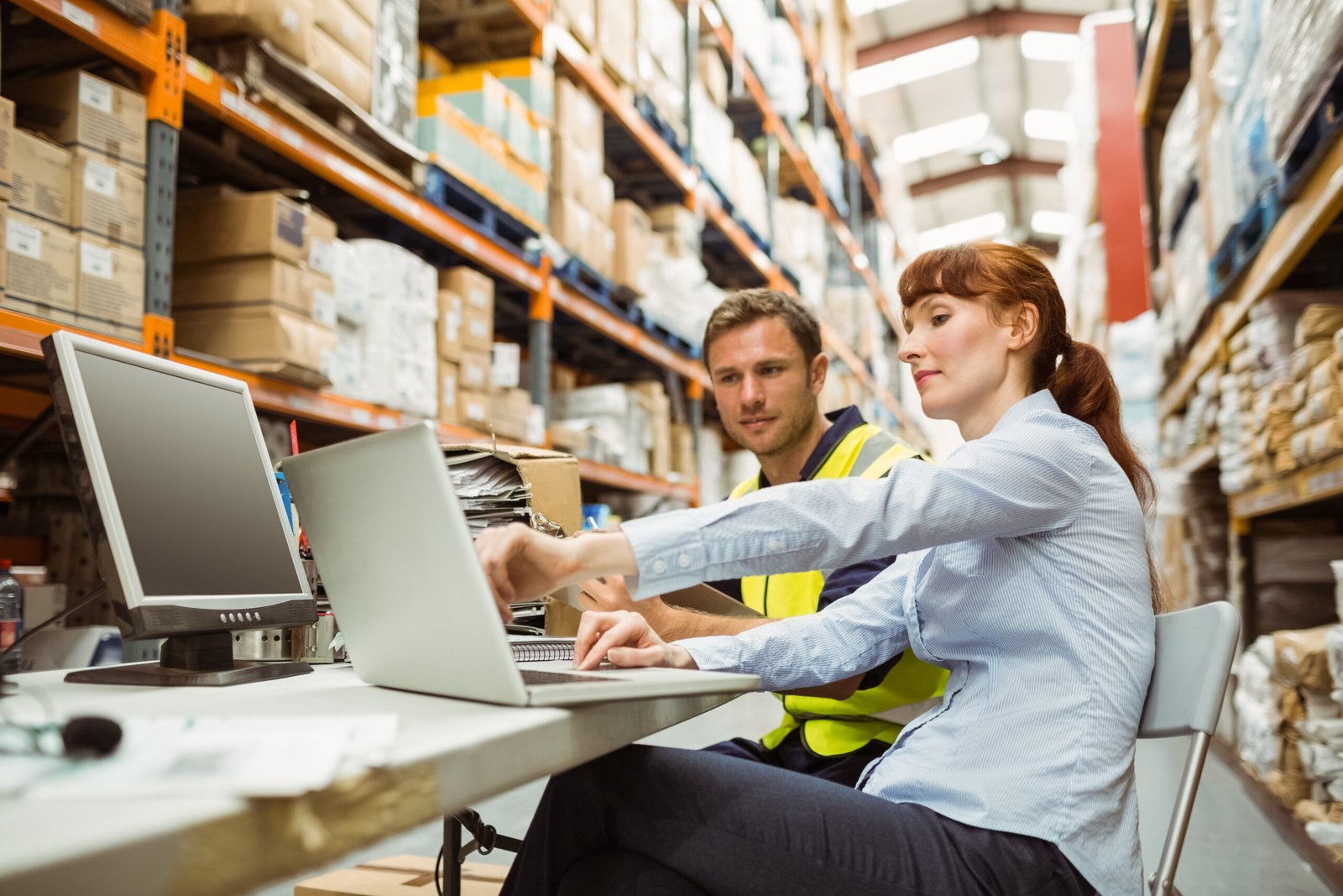 Warehouse,Worker,And,Manager,Looking,At,Laptop,In,A,Large